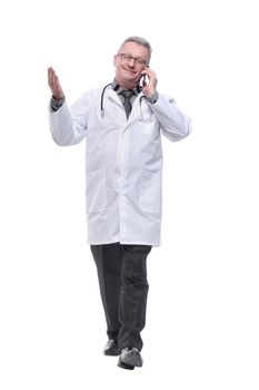 Middle age handsome grey-haired doctor man talking smartphone isolated white background