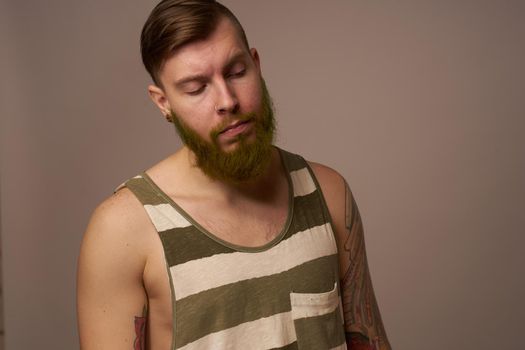 national bearded man in a striped jersey hipster tattoos on his arms