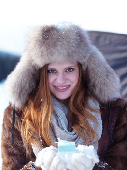 portrait of  girl with gift at winter scene and snow in backgrond