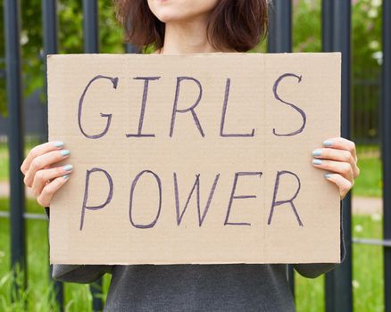Girl Power concept. Unrecognizable person holds sign with text about feminism