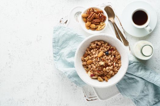 Dry granola in bowl. Breakfast, healthy diet food with milk in bottle