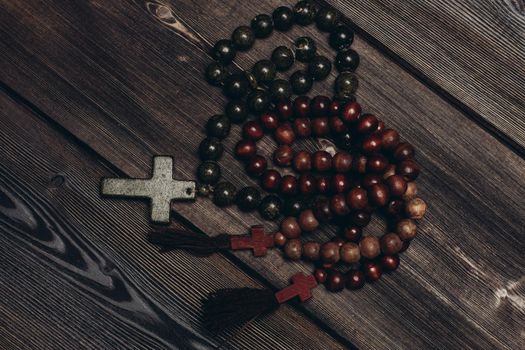 beads with orthodox cross wooden background catholicism christianity