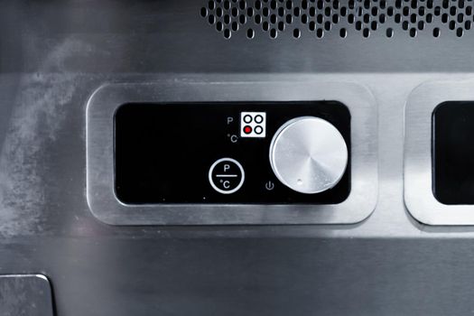Commercial kitchen appliance temperature controls close up