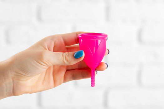 Woman holding menstrual cup in hand close up