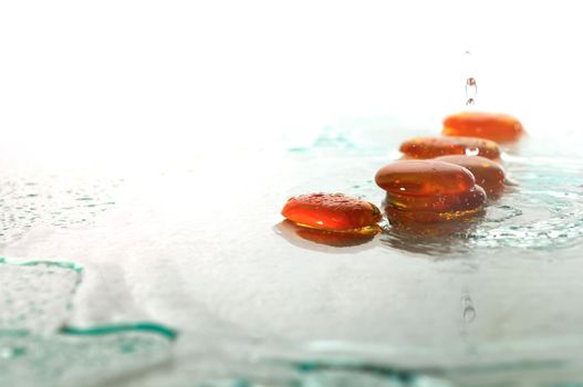 isolated wet zen stones with splashing  water drops