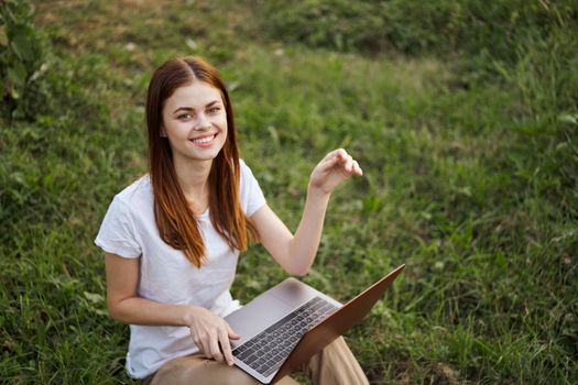 cheerful woman outdoors laptops communication internet. High quality photo