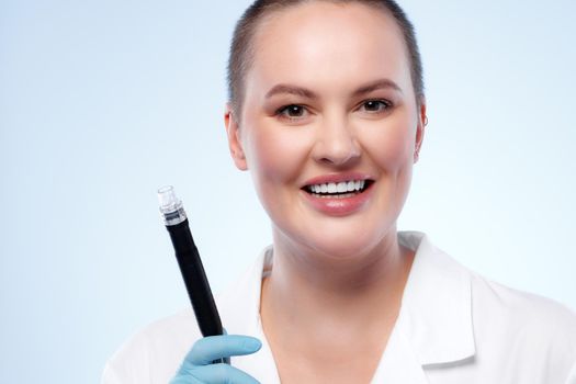 Portrait of a woman dermatologist holding cosmetic device attachment