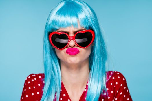 emotional woman blue wig sunglasses posing fashion. High quality photo