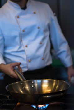 chef preparing food, frying in wok pan