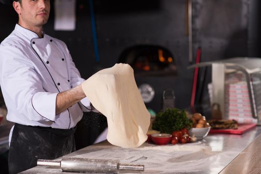 chef throwing up pizza dough