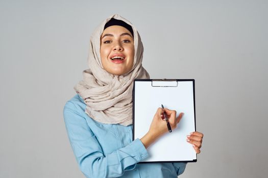 Muslim woman in hijab documents office work