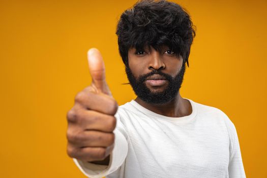 Happy young black man giving thumbs up
