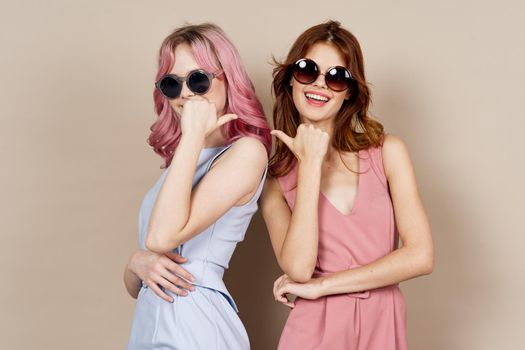 two girlfriends stand side by side fashion clothing glamor posing