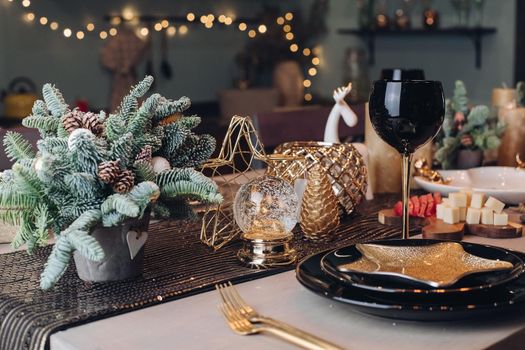 Thanksgiving table setting among white candles and cones