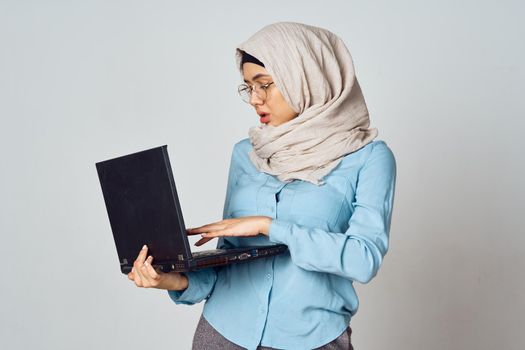 muslim woman in hijab with laptop coffee cup work