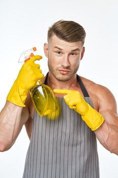 cheerful man in apron detergent posing muscles