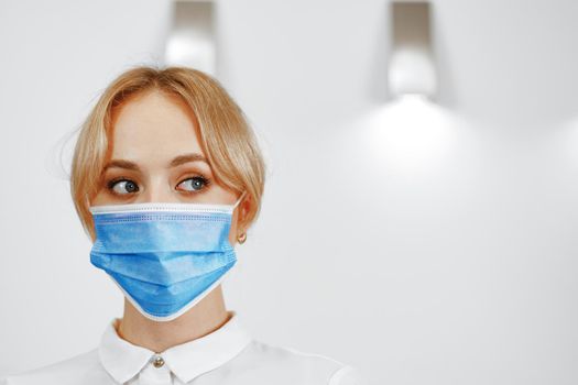 Close up portrait of woman hotel receptionist wearing medical mask