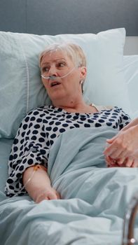 Senior patient with illness discussing treatment with doctor