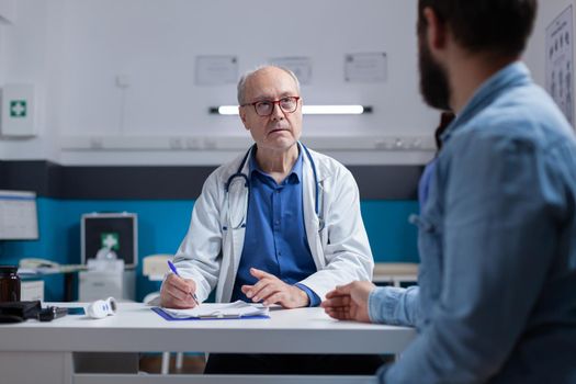 Doctor and patient having discussion about diagnosis at checkup visit