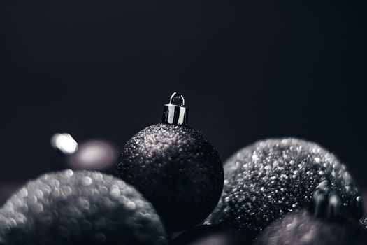 Christmas holiday and festive decoration concept. Black baubles as minimalistic xmas background