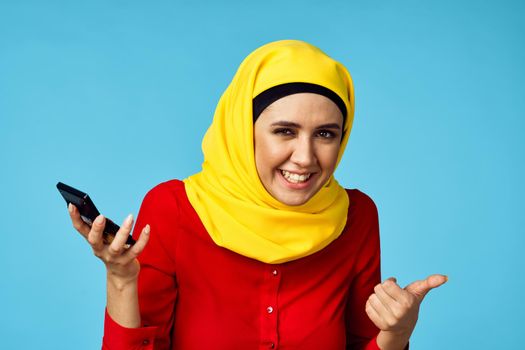 muslim woman in hijab shopping entertainment blue background