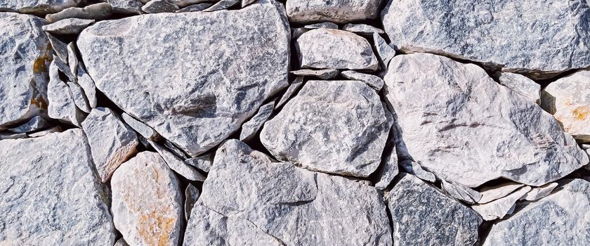 Stone texture and exterior design concept. Stonewall made of natural rocks as architectural surface background