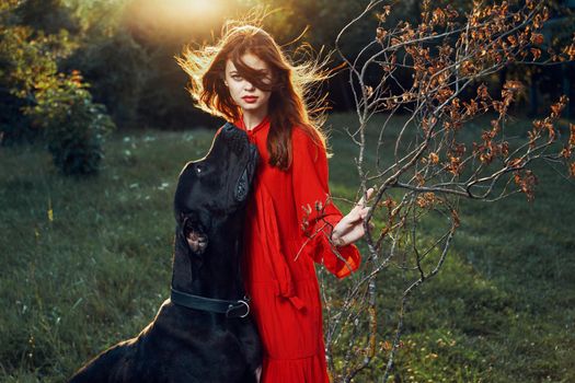 fashion attractive woman in black purebred dog outdoors