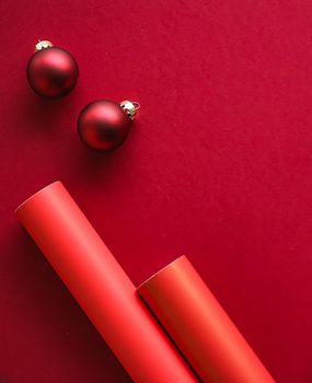 Christmas flatlay and holiday design concept. Decoration, ornament and xmas gift wrapping on red paper background as flat lay top view