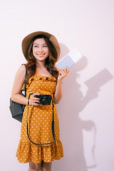 Beautiful travel woman with passport isolated on pastel backgroun