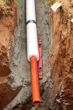 Installation of water main, sanitary sewer, storm drain systems, plastic pipes wrapped in insulation.	