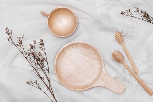 Different wooden kitchenware on wooden table, close up