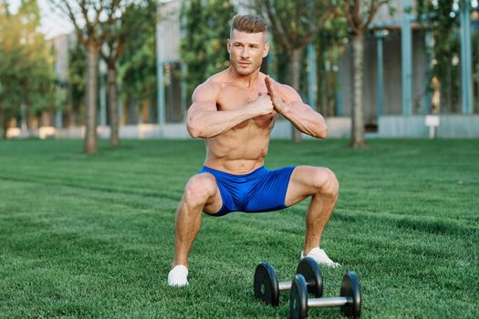 Muscled Man Doing Exercises Outdoor Fitness Summer. High quality photo