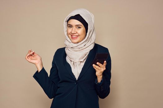 muslim woman with calculator in hands work office business