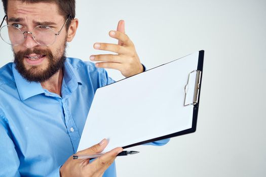 bearded man in blue shirt documents manager professional