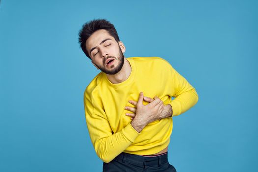 man in yellow sweater health problems emotions blue background