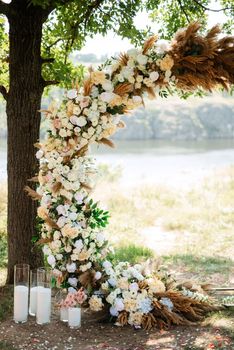 wedding ceremony area with dried flowers in a meadow in a forest