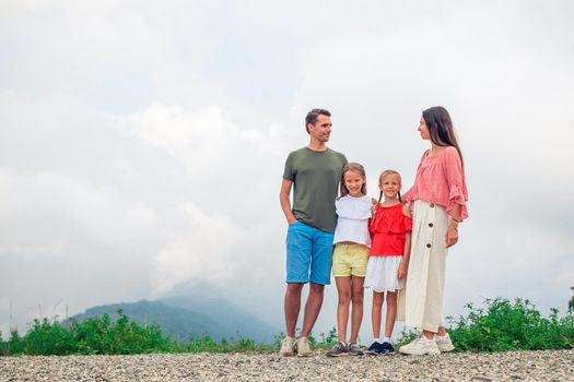 Beautiful happy family in mountains in the background of fog