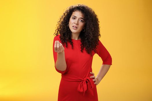 Girl being pissed off arguing ad complaining making italian what do you want gesture looking bothered waiting for explanation as standing annoyed and fed up over yellow background