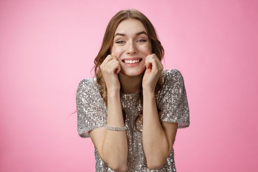 Ehtusiastic attractive young birthday girl celebrating throw party invite friends smiling happily having fun fantastic day pulling cheeks sincere grin standing delighted amused pink background