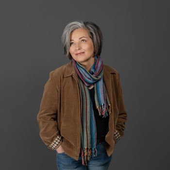 Pretty mid aged grey haired woman in casual portrait. Happy business woman smiling. Human emotions, facial expression concept. Different facial expressions, emotions, feelings