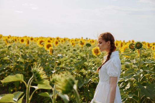 beautiful sweet girl in a hat on a field of sunflowers countryside. High quality photo