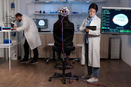 Neurologist engineer doctor monitoring brain activity evolution during neuroscience experiment
