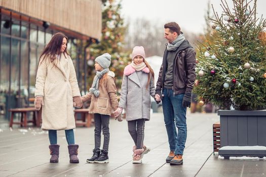 Family of four at winter day outdoors
