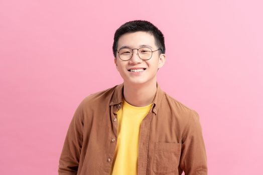 Smiling Vietnamese young man in glasses looking at camera
