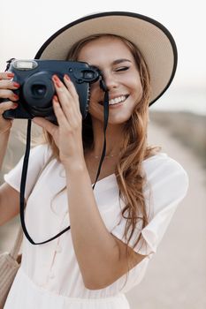 happy young woman with camera outdoor