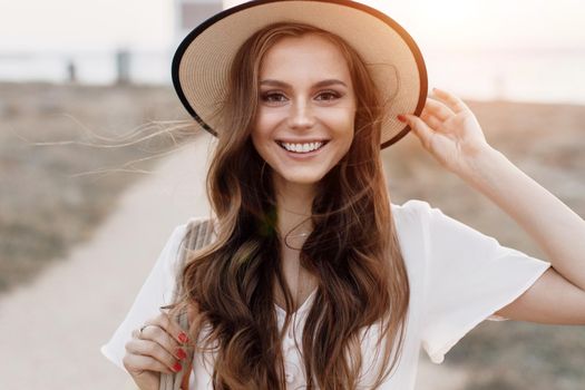 Young happy smiling woman in hat outdoor
