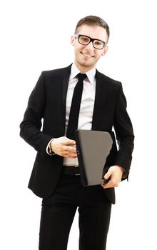 Business man holding a laptop and smiling.