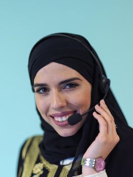 muslim woman with headset on cyan background