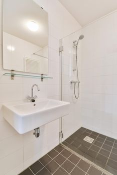 Stylish bathroom with brown tiled floor