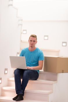 young man sitting in stairway at home